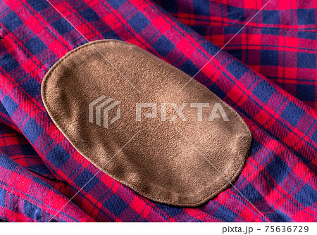 Red check clothes and brown patch on the sleeve, macro 75636729