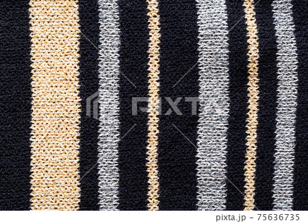 Modern clothes with black and brown stripes, background, macro. Material 75636735