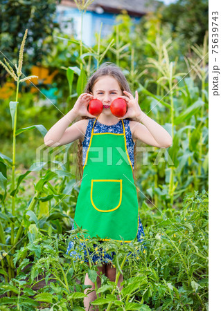 Child and vegetables on the farm. 75639743