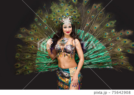National dancer in a luxurious outfit of bird feathers on a black background, isolated 75642908