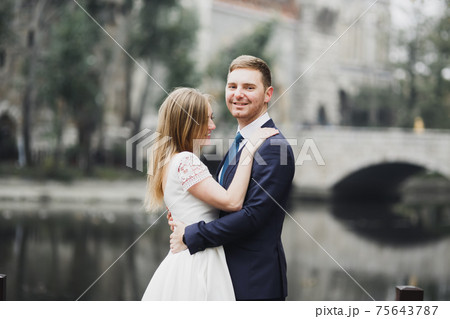 Sensual portrait of a young wedding couple. Outdoor 75643787