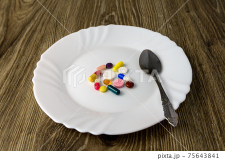 A bunch of pills on a plate A bunch of pills on a plate 75643841