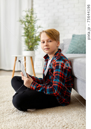 child boy in checkered shirt using digital tablet 75644196