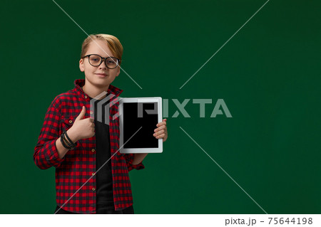 child boy in red checkered shirt shows empty tablet child boy in red checkered shirt shows empty tablet 75644198