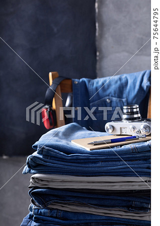 Denim jeans and old retro concept at old wooden chair near grey wall background texture Denim jeans and old retro concept at old wooden chair near grey wall background texture 75644795