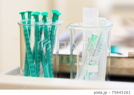 Two measuring cups filled with injections in laboratory 75645261