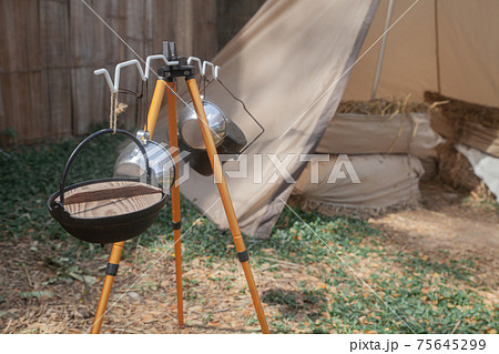 Iron pot soup hang on metal campfire for cooking . 75645299