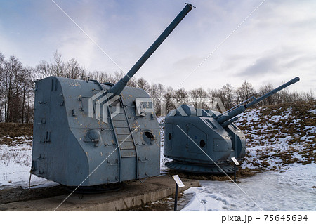 Russia. March 14, 2021. The AK-176 automatic naval artillery system and the B-34USM artillery system are displayed in the open air as museum exhibits in the Patriot Park in Kronstadt. 75645694