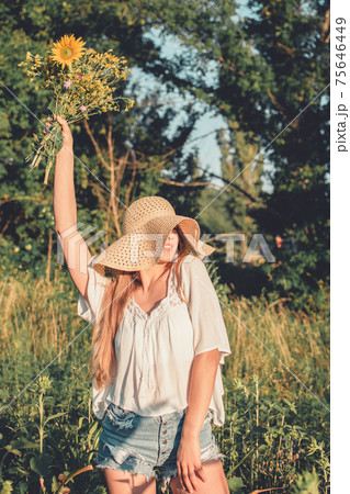 Sun Protection, sunscreen , UV protection, Time Outside and Stay Sun-safe. Young woman with straw hat protects from sun and enjoying nature Sun Protection, sunscreen , UV protection, Time Outside and Stay Sun-safe. Young woman with straw hat protects from sun and enjoying nature 75646449
