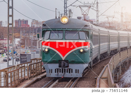 Retro passenger train approaches to the station. 75651146