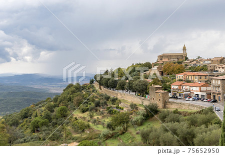 The Montalcino Cathedral and houses on the hill, fortress wall around Montalcino, Tuscany, Italy The Montalcino Cathedral and houses on the hill, fortress wall around Montalcino, Tuscany, Italy 75652950