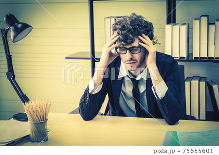 Depressed office worker business manger with frustrated expression on office desk feeling despair about business problem. 75655601