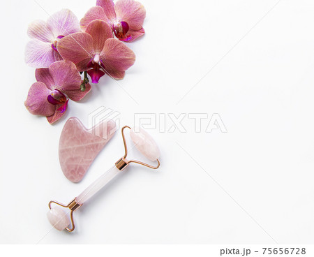 Face massage jade rollers on white background Face massage jade rollers on white background 75656728