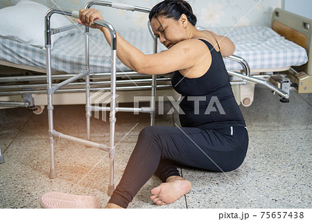 Asian middle-aged lady woman patient falling in living room because slippery surfaces 75657438