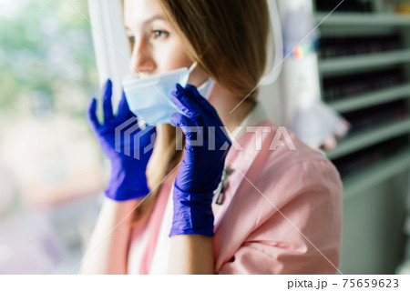 Beautiful female medical worker or manicure master in a mask 75659623