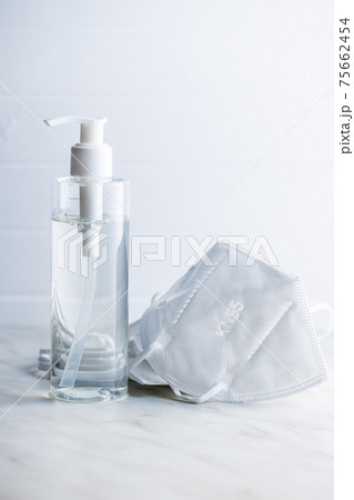 Coronavirus prevention hand sanitizer and kn95 respirator mask. Hand disinfectant gel in pump bottle. Coronavirus prevention hand sanitizer and kn95 respirator mask. Hand disinfectant gel in pump bottle. 75662454