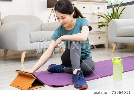 Woman exercise at home 75664011