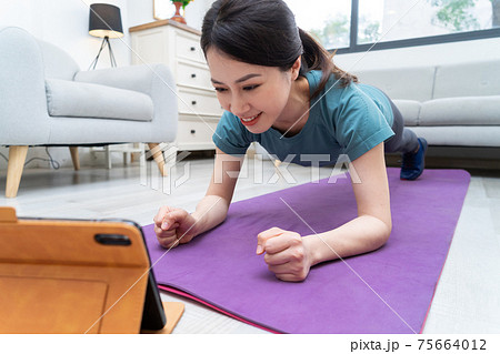Woman exercise at home 75664012
