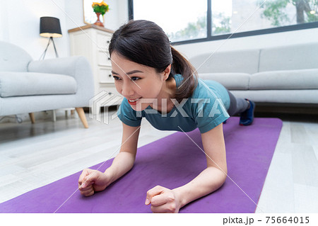 Woman exercise at home 75664015