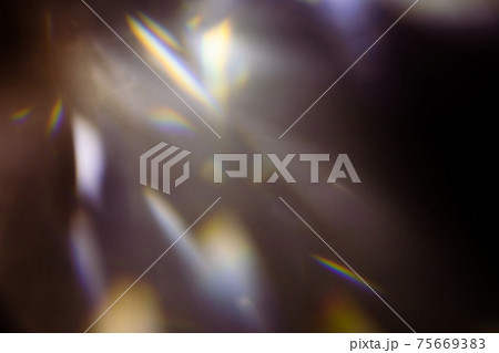 colorful warm rainbow light leaks on black background with dust texture 75669383