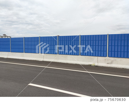 SELANGOR, MALAYSIA - JULY 2, 2020: Noise barriers are installed along the vehicle lane bordering the residence to prevent noise pollution to the locals. SELANGOR, MALAYSIA - JULY 2, 2020: Noise barriers are installed along the vehicle lane bordering the residence to prevent noise pollution to the locals. 75670630
