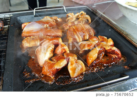 The squid is sliced and marinated with spices. Grilled on a frying pan. 75670652