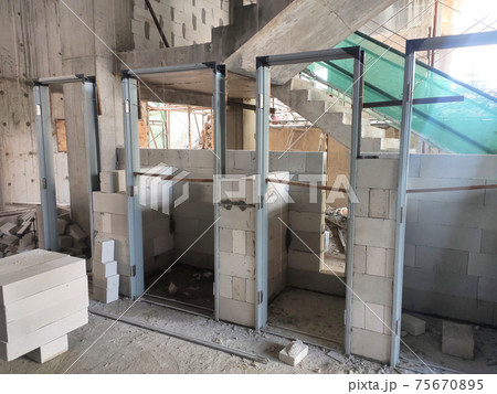 SEREMBAN, MALAYSIA -MARCH 15, 2020: Blockwork by construction workers at the construction site. Workers laying the AAC brick and stacked it together using mortar to form the wall.  75670895