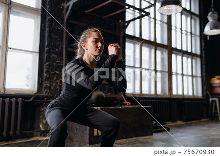 Young girl doing sports in the gym. Atmospheric gym Young girl doing sports in the gym. Atmospheric gym 75670930