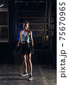 Young girl stands in an atmospheric gym. Sport 75670965