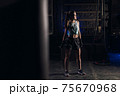 Young girl stands in an atmospheric gym. Sport 75670968