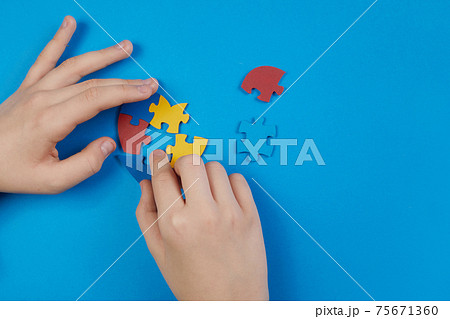World Autism Awareness day, mental health care concept with puzzle or jigsaw pattern on heart with child's hands World Autism Awareness day, mental health care concept with puzzle or jigsaw pattern on heart with child's hands 75671360