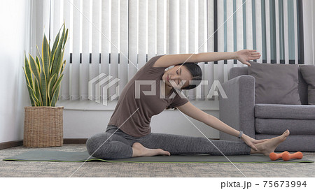 Slim fit Asian woman Internet coach yoga and meditation coaching videos make them feel relaxed, female happiness, Stretching the muscles of the body and practicing proper breathing, Exercise concept. Slim fit Asian woman Internet coach yoga and meditation coaching videos make them feel relaxed, female happiness, Stretching the muscles of the body and practicing proper breathing, Exercise concept. 75673994
