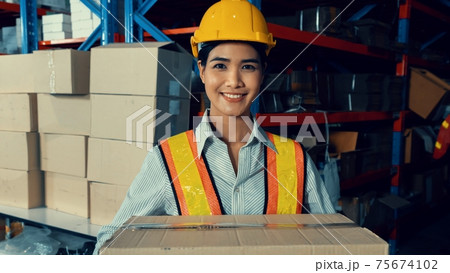 Portrait of young Asian woman warehouse worker smiling in the storehouse Portrait of young Asian woman warehouse worker smiling in the storehouse 75674102