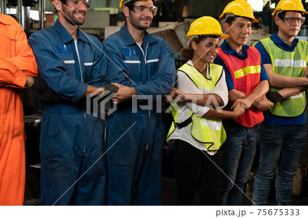 Skillful worker stand together showing teamwork in the factory . Skillful worker stand together showing teamwork in the factory . 75675333