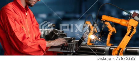 Engineer use advanced robotic software to control industry robot arm in factory Engineer use advanced robotic software to control industry robot arm in factory 75675335
