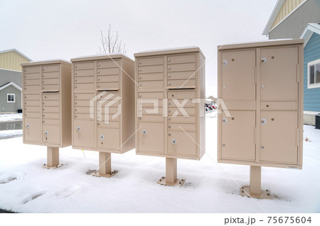 Cluster mailboxes with compartments for residents of a snowy neighborhood Cluster mailboxes with compartments for residents of a snowy neighborhood 75675604