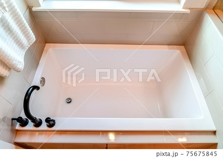 Top view of a built in rectangular bathtub inside the clean bathroom of a home Top view of a built in rectangular bathtub inside the clean bathroom of a home 75675845