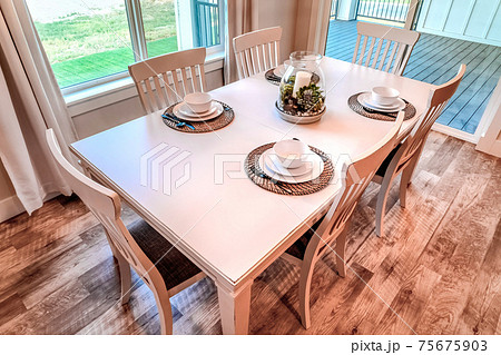 Dining area of home with access to deck that looks out to a view of the yard 75675903