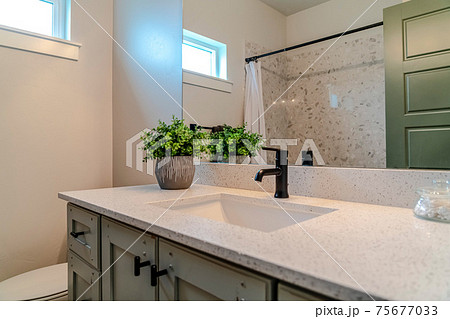 Bathroom interior of home with single basin sink over cabinets and countertop 75677033