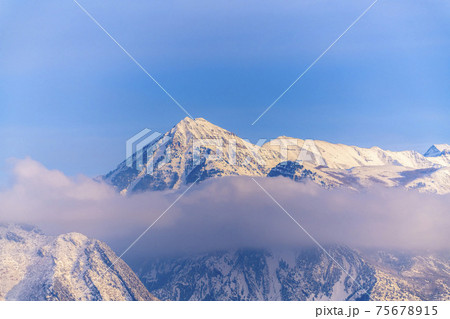 Striking snow covered Mount Timpanogos with blue sky background in winter 75678915