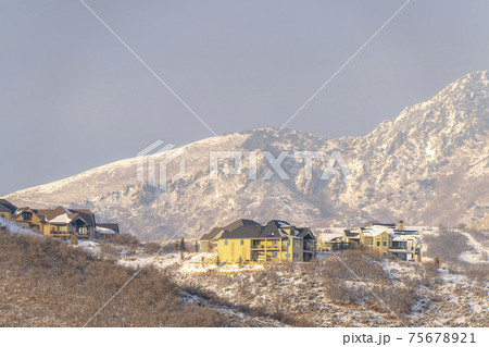 Tranquil neighborhood with homes that have a view of natural beauty in winter Tranquil neighborhood with homes that have a view of natural beauty in winter 75678921