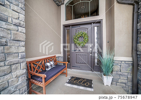 Beautiful home entrance with gray door sidelights and huge transom window 75678947