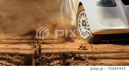 Rally race car drifting on dirt track. 75684445