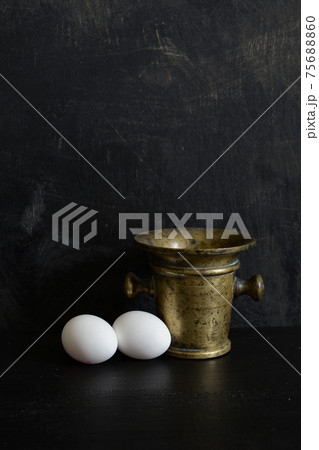 Antique brass Mortar and two white eggs Antique brass Mortar and two white eggs 75688860