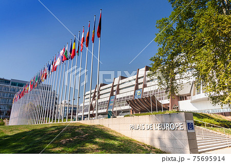 Strasbourg, France, August 2019. Three-quarter view of the Palace of Europe, the building that houses the headquarters of the Council of Europe. In evidence the banidiere of the member states. Strasbourg, France, August 2019. Three-quarter view of the Palace of Europe, the building that houses the headquarters of the Council of Europe. In evidence the banidiere of the member states. 75695914