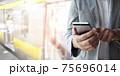 Businessman use smartphone for booking a ticket. 75696014