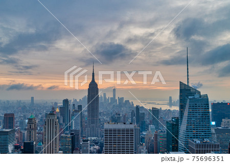 New York skyline from the top of The rock observation deck in Rockefeller center sunset view with clouds in the sky New York skyline from the top of The rock observation deck in Rockefeller center sunset view with clouds in the sky 75696351