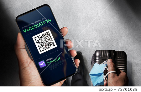 Health Vaccine Passport for Coronavirus or Covid-19. Traveller Using Mobile Phone with Vaccination in Immune Status to Certificated International Traveling  in Airport 75701038