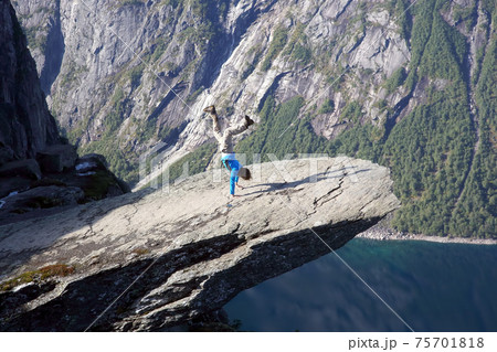 man stands on his hands in Troll language. Norway 75701818