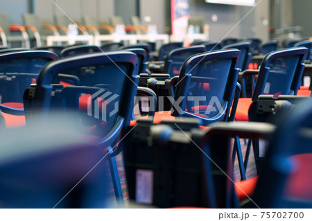 Red and black conference chairs in the auditorium 75702700